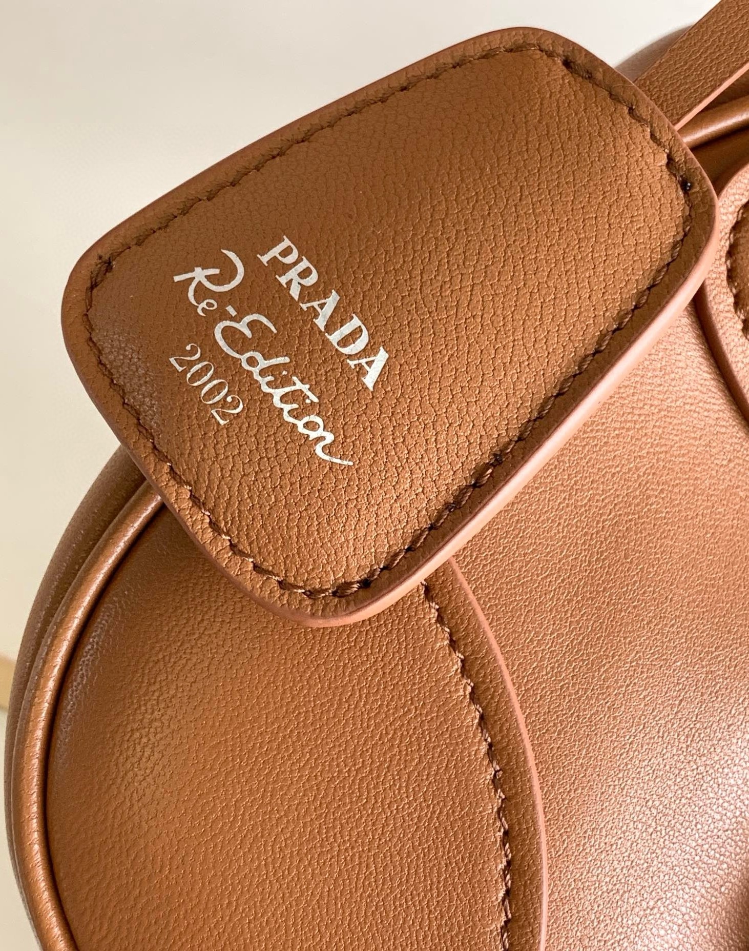 Pra*a moon bag in caramel padded nappa leather