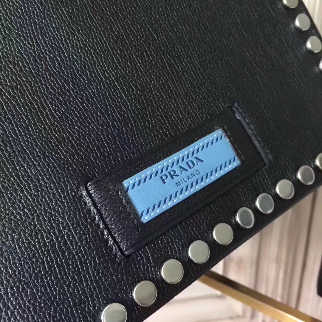 Pra*a etiquette bag in black calfskin with metal stud trim
