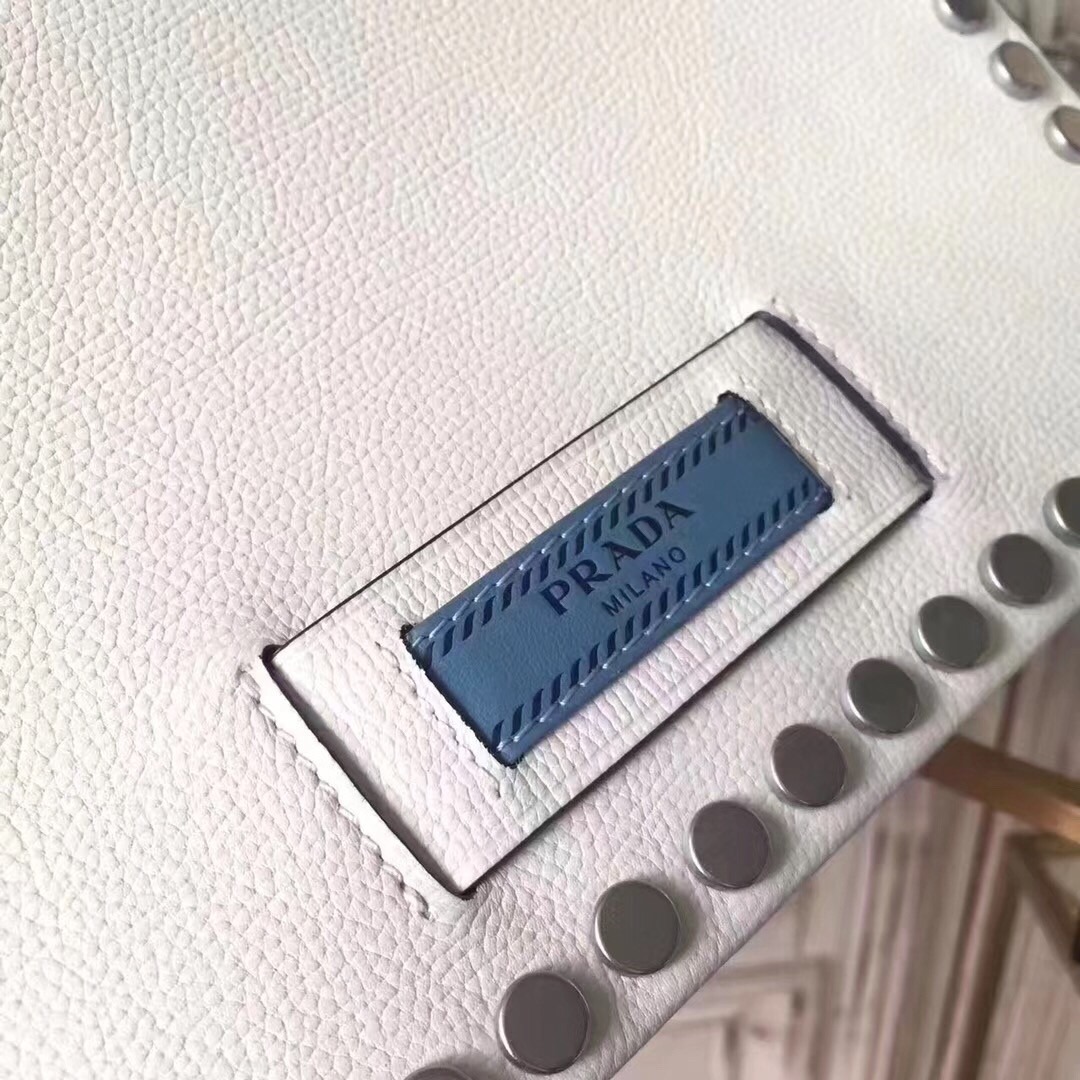 Pra*a etiquette bag in white calfskin with metal stud trim