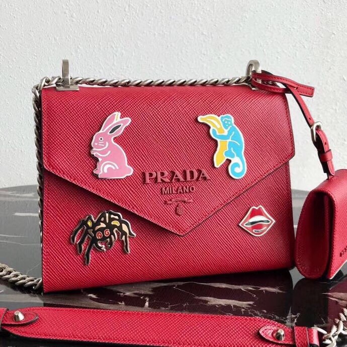 pra*a red monoCh*0me flap bag with metal appliques