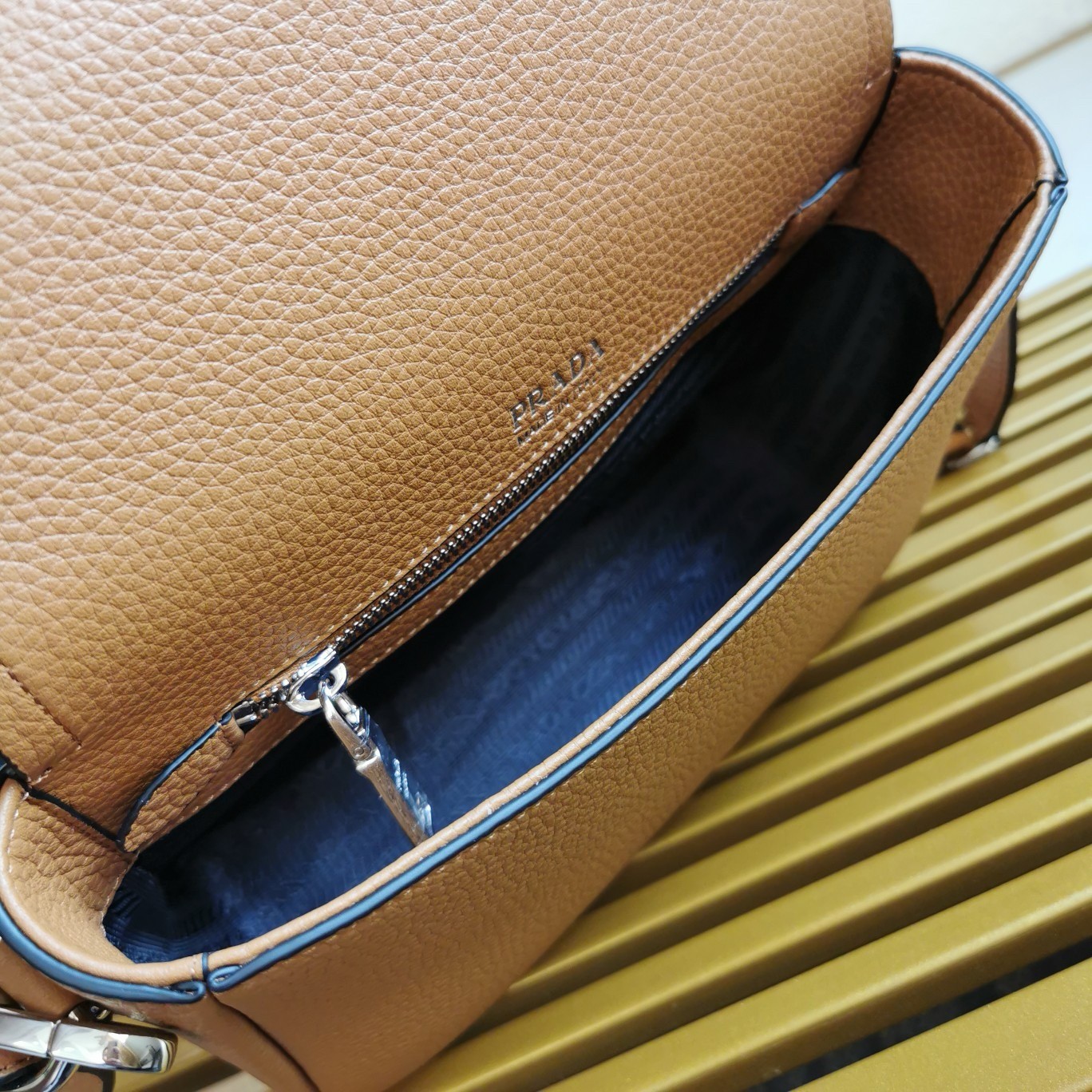 Pra*a flap shoulder bag in brown grained leather