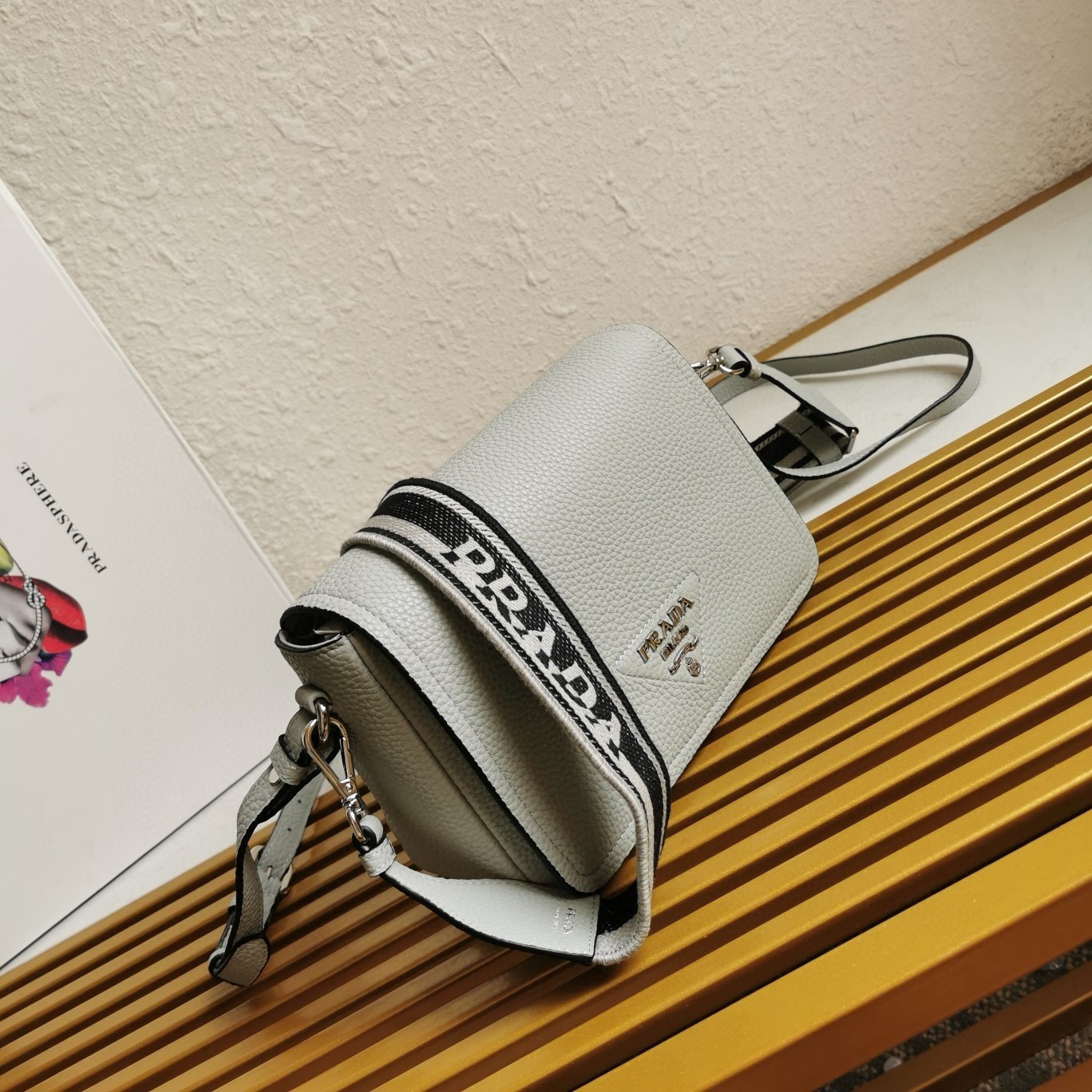 Pra*a flap shoulder bag in cornflower grained leather
