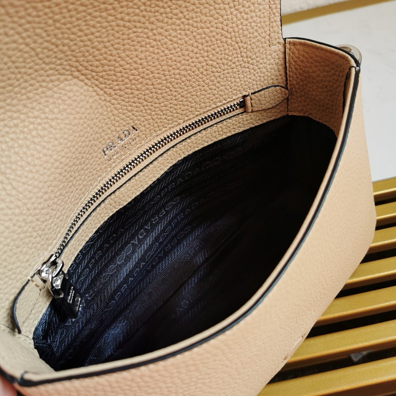 Pra*a flap shoulder bag in sand grained leather