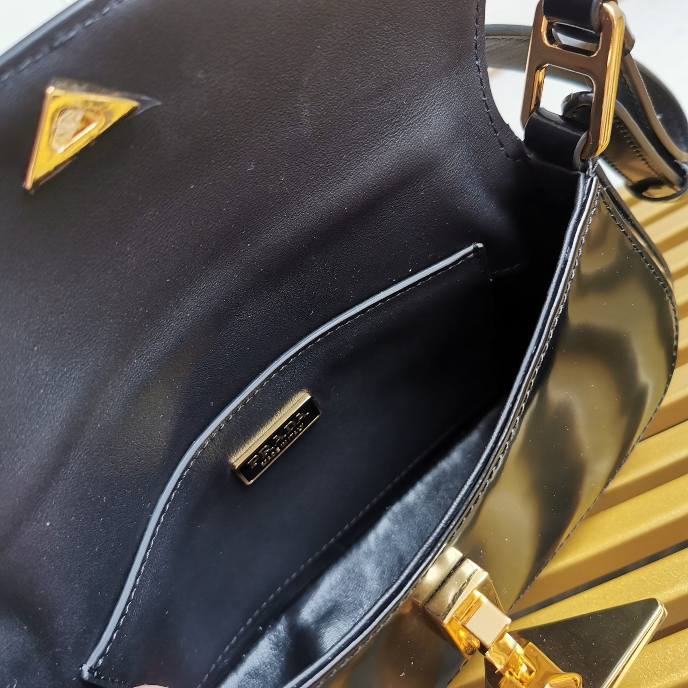Pra*a shoulder bag in black brushed calfskin