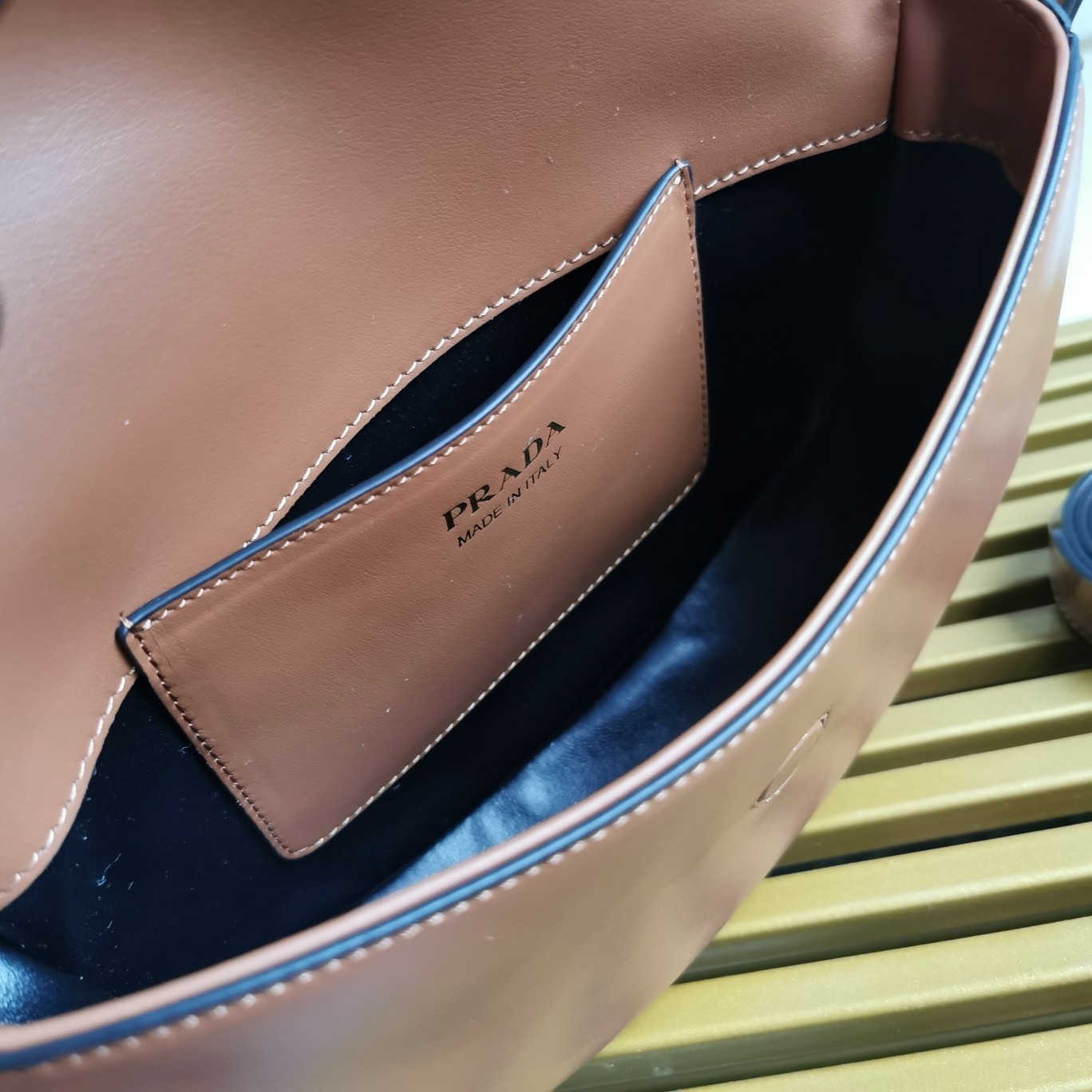 Pra*a arque shoulder bag with flap in brown leather