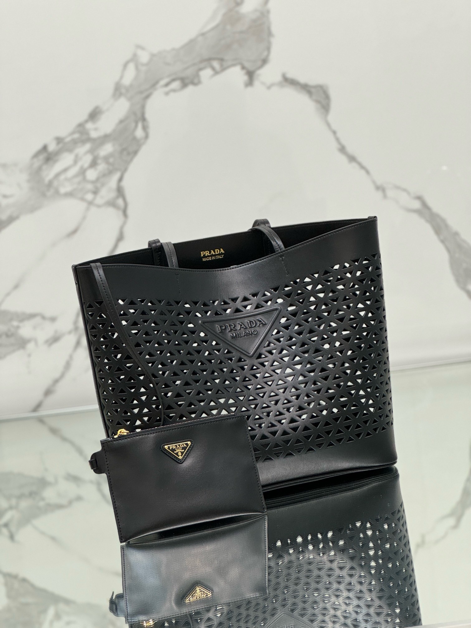 Pra*a large tote bag in black perforated leather