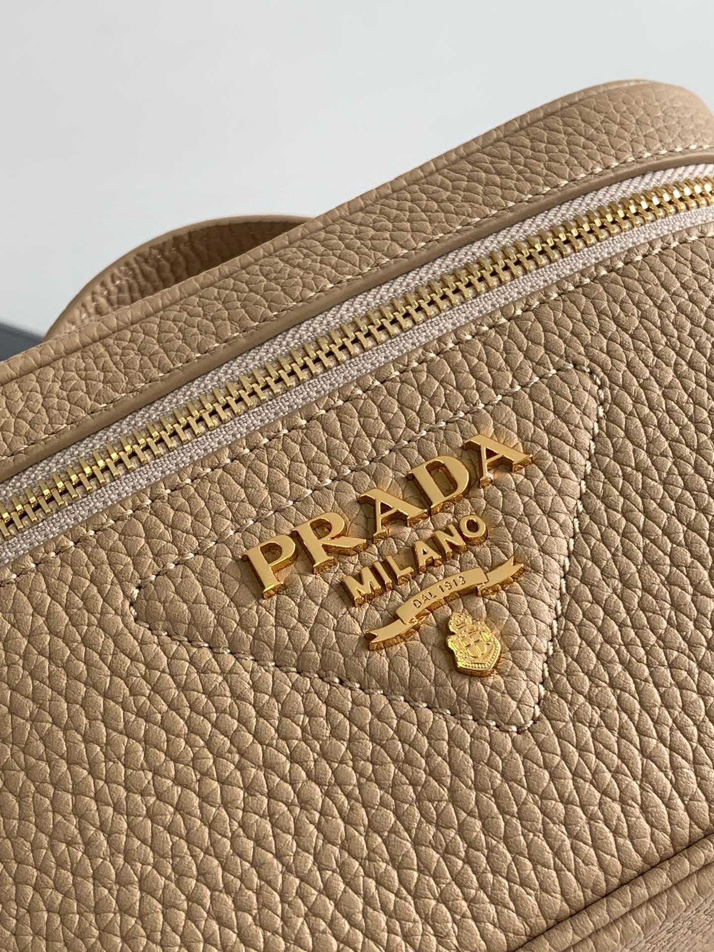 Pra*a mini vanity bag in sand beige grained leather