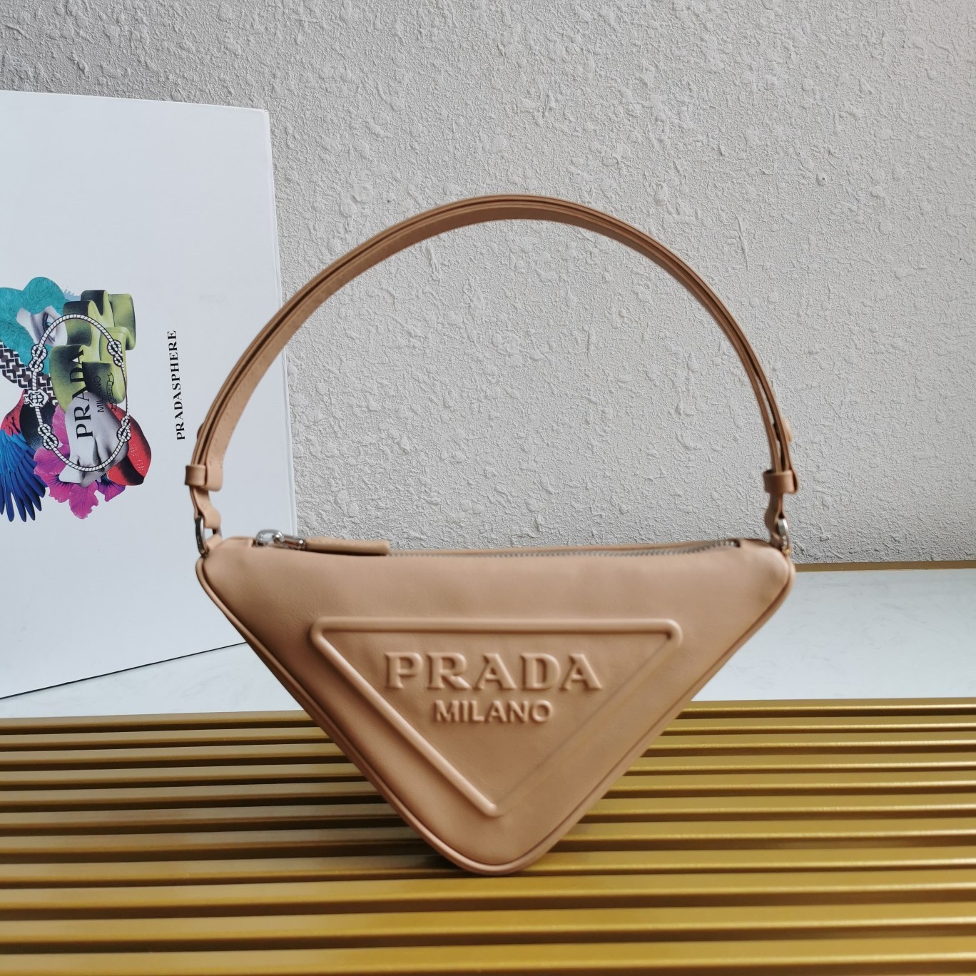 Pra*a triangle pouch bag in beige leather