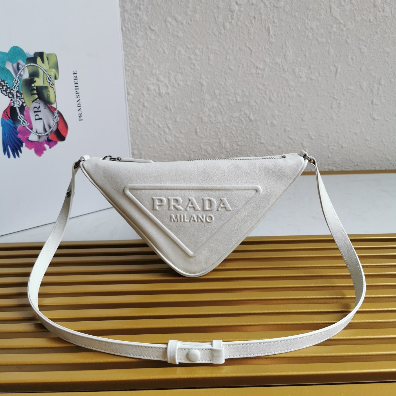 Pra*a triangle pouch bag in white leather