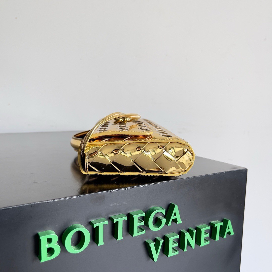 bo*te*ga Ve*ne*ta andiamo clutch with handle in gold metallic leather