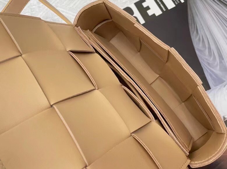bo*te*ga Ve*ne*ta cassette belt bag in beige intrecciato leather