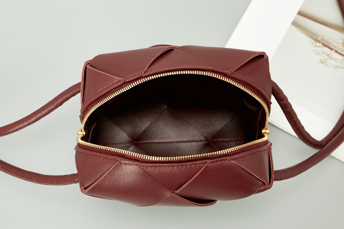 bo*te*ga Ve*ne*ta mini cassette camera bag in bordeaux lambskin