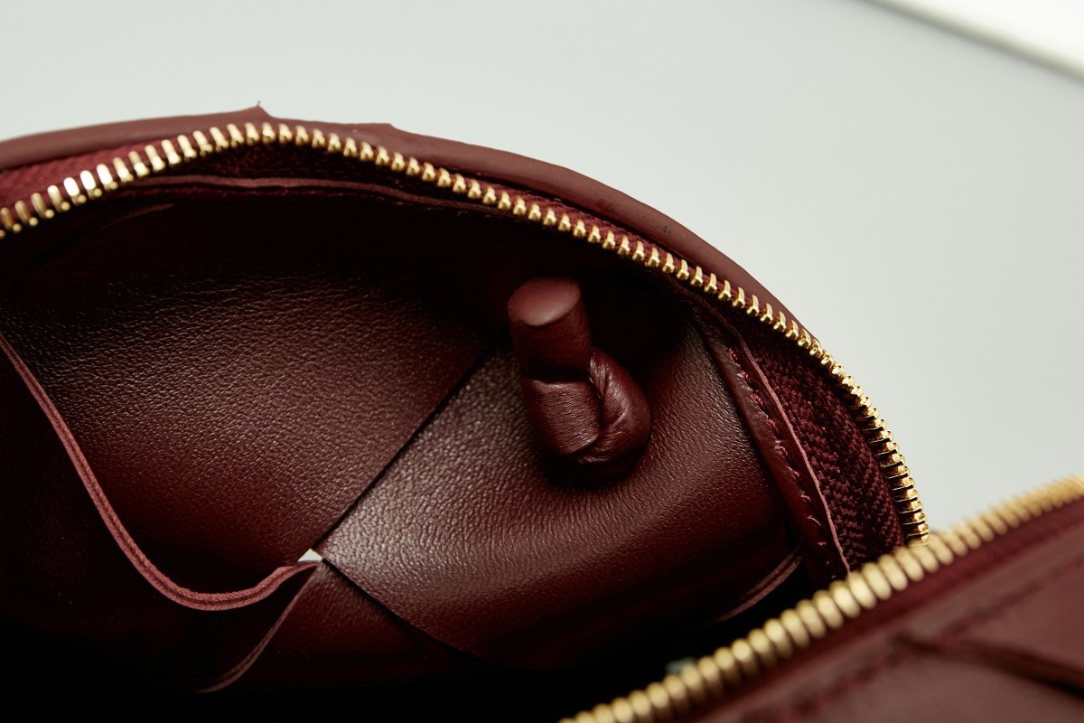 bo*te*ga Ve*ne*ta mini cassette camera bag in bordeaux lambskin