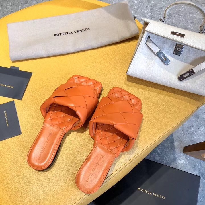 bo*te*ga Ve*ne*ta lido slides in orange intreccio lambskin