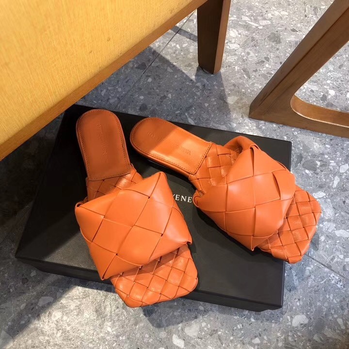 bo*te*ga Ve*ne*ta lido slides in orange intreccio lambskin