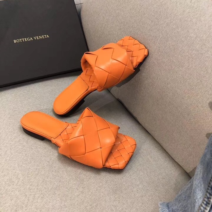 bo*te*ga Ve*ne*ta lido slides in orange intreccio lambskin