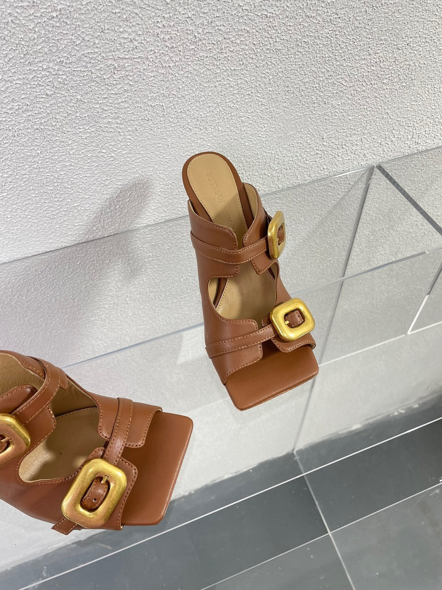 bo*te*ga Ve*ne*ta stretch buckle mules in caramel calfskin