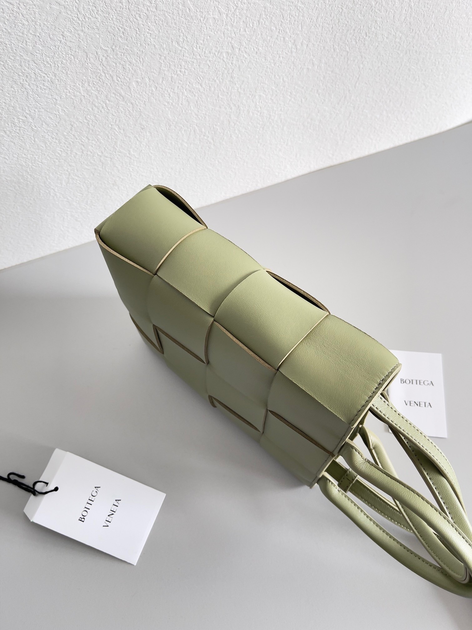 bo*te*ga Ve*ne*ta mini cassette tote bag in travertine lambskin