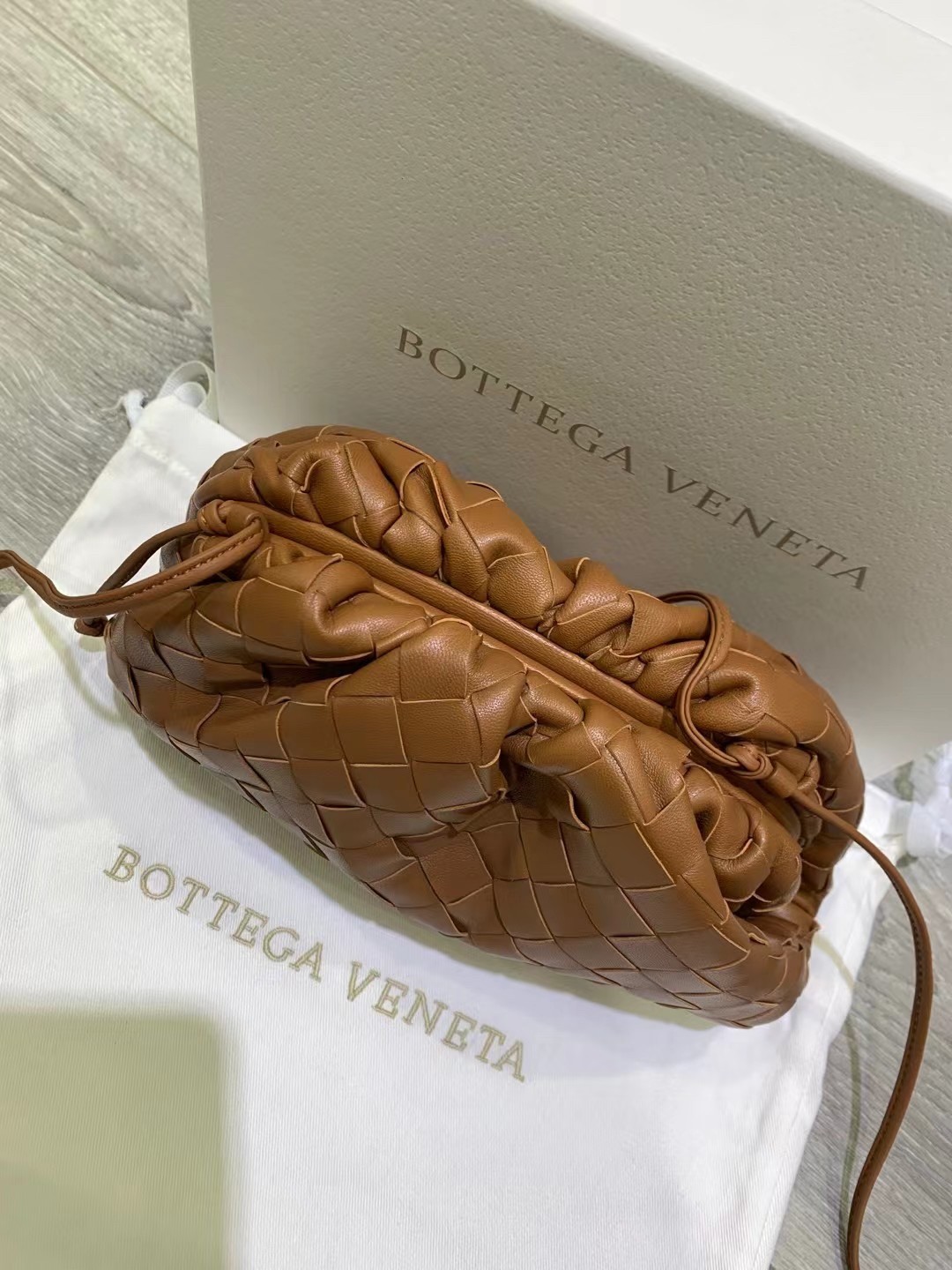 bo*te*ga Ve*ne*ta mini pouch in caramel intrecciato lambskin