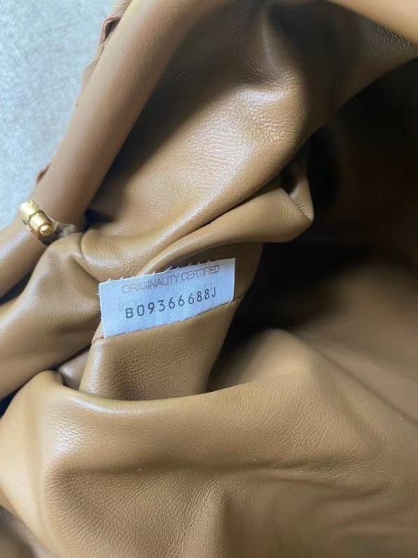 bo*te*ga Ve*ne*ta large pouch clutch in caramel intrecciato lambskin