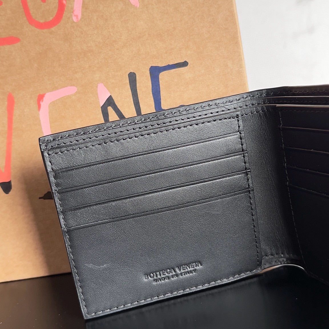 bo*te*ga Ve*ne*ta bi-fold wallet in black intrecciato calfskin