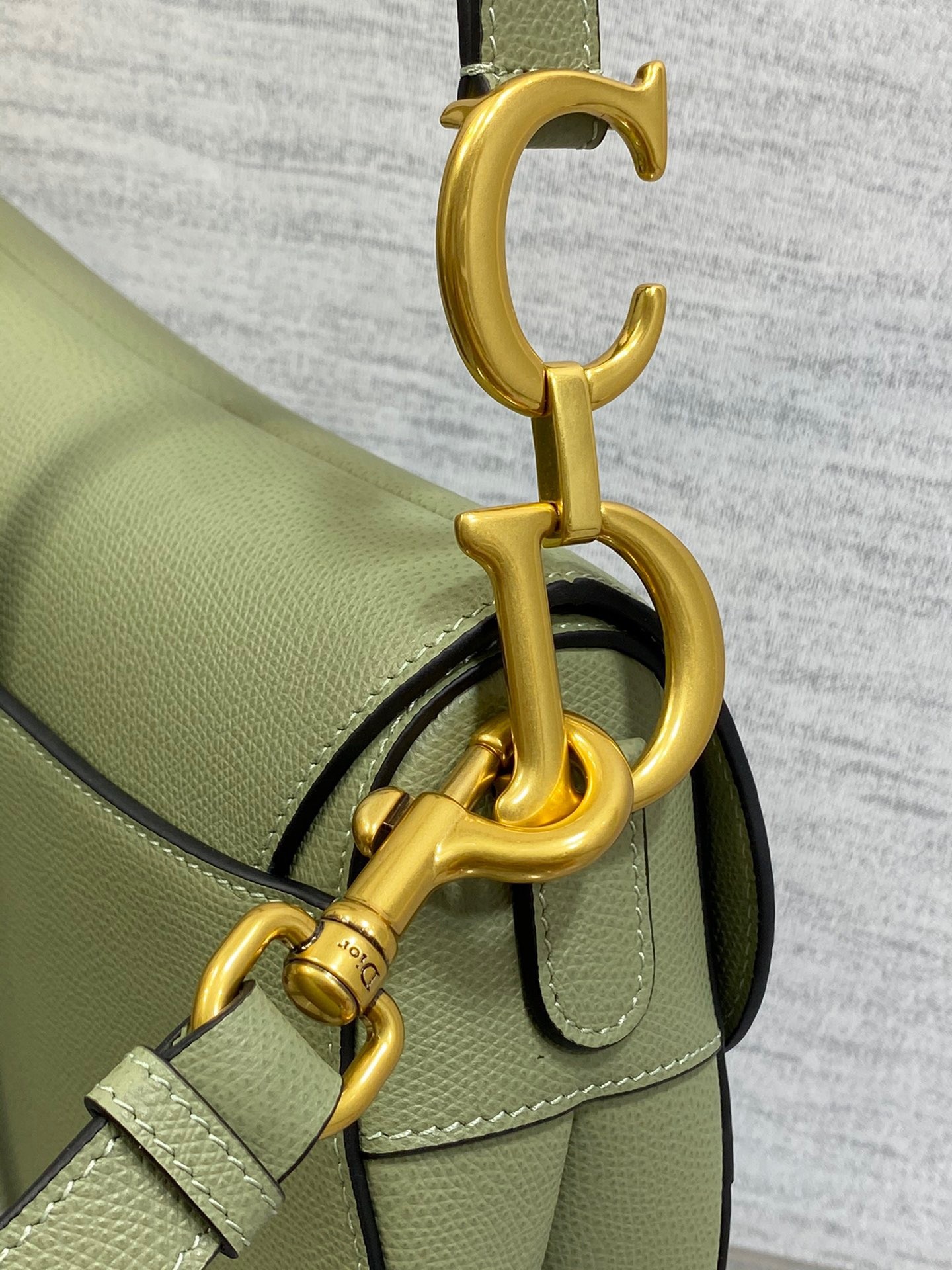 D*or saddle bag with strap in ethereal green grained calfskin