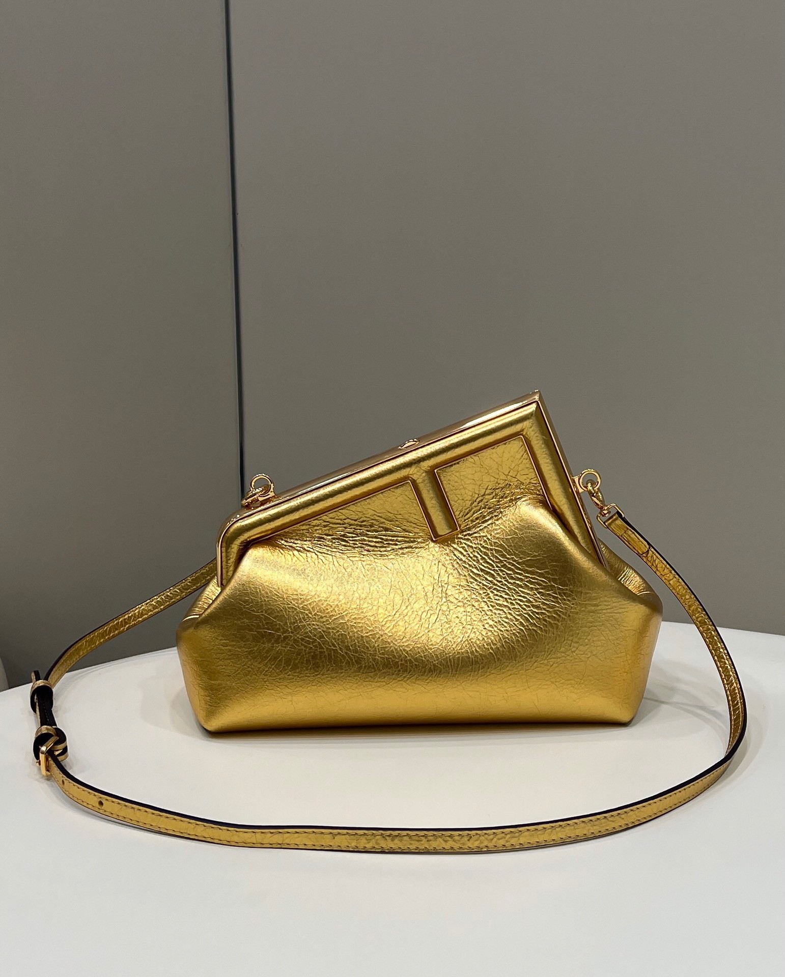 F**di first small bag in gold laminated leather