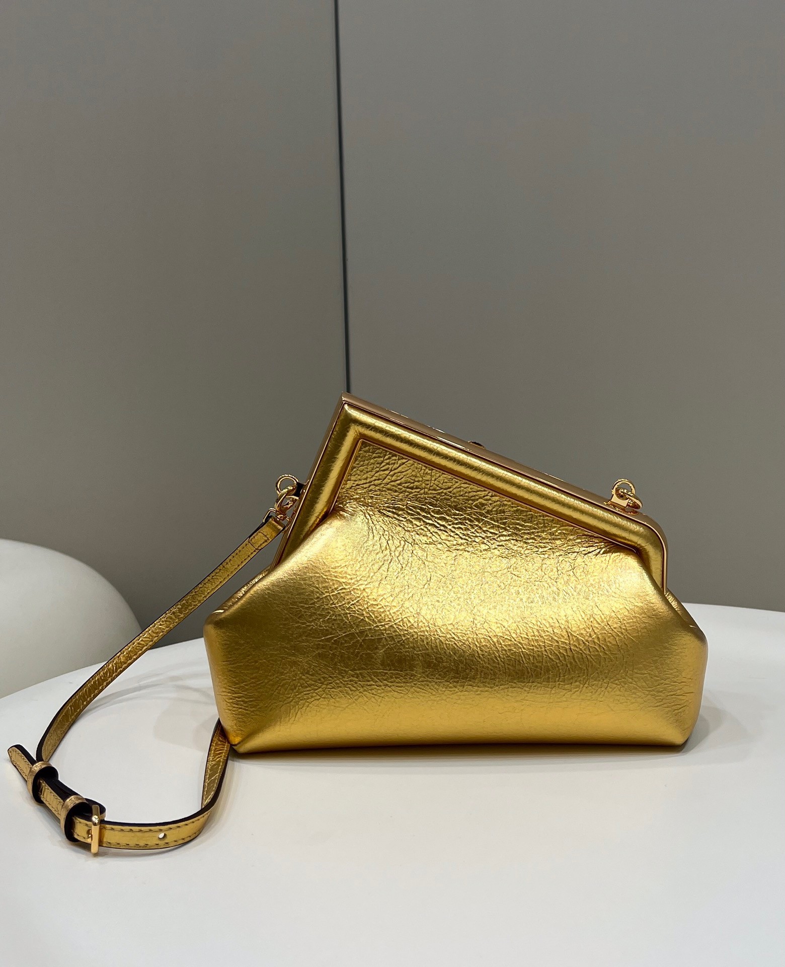 F**di first small bag in gold laminated leather