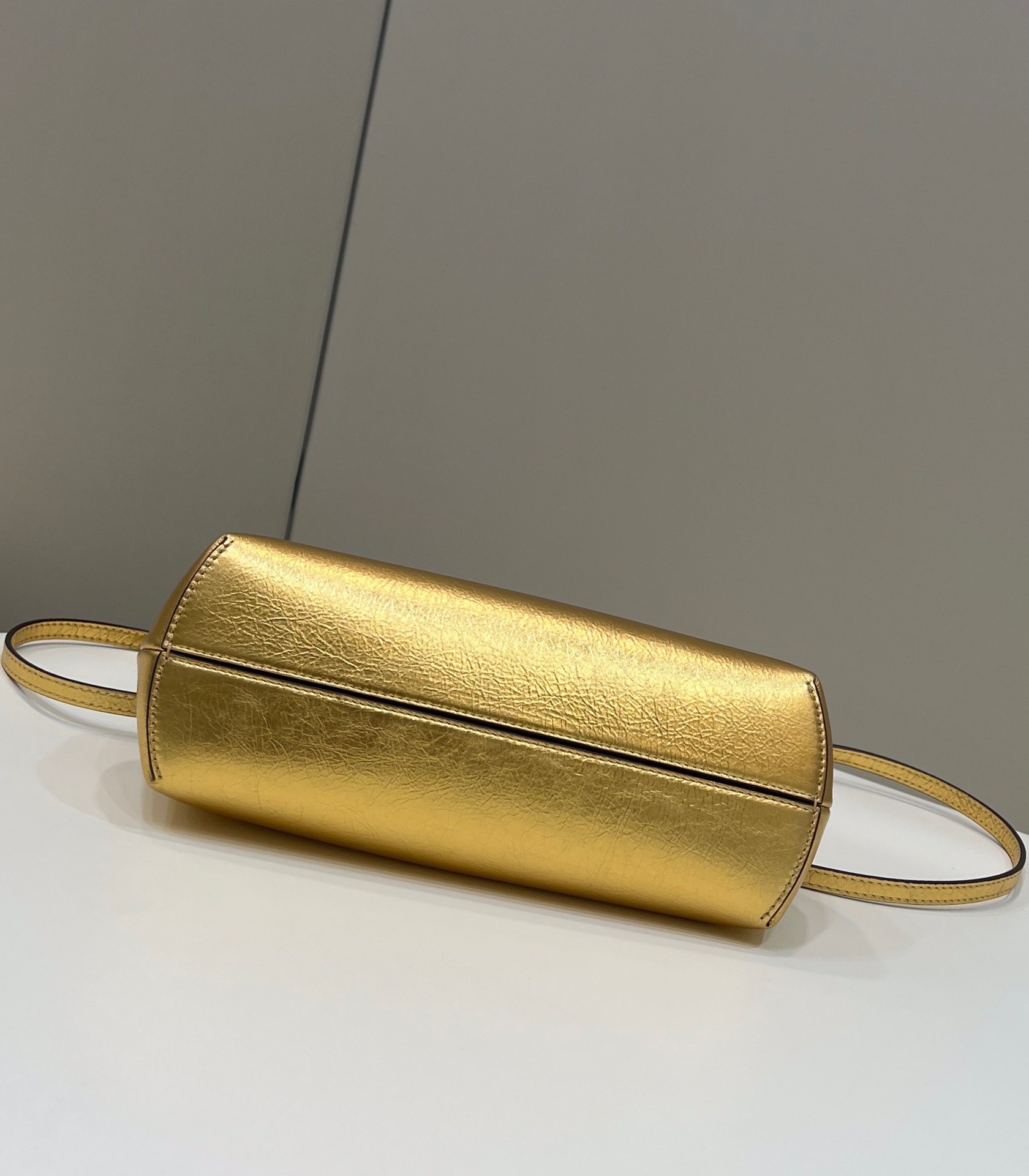 F**di first small bag in gold laminated leather