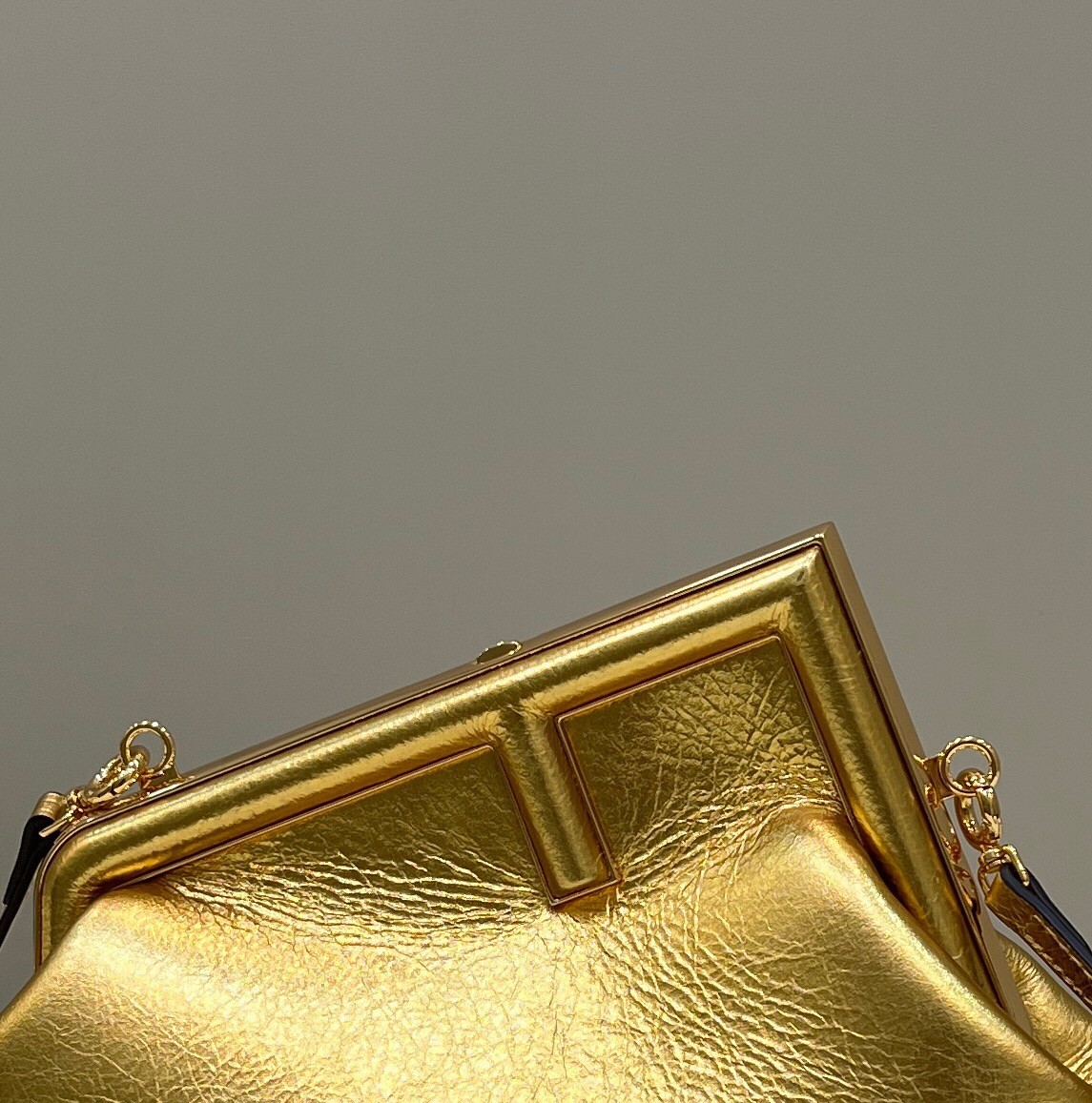 F**di first small bag in gold laminated leather