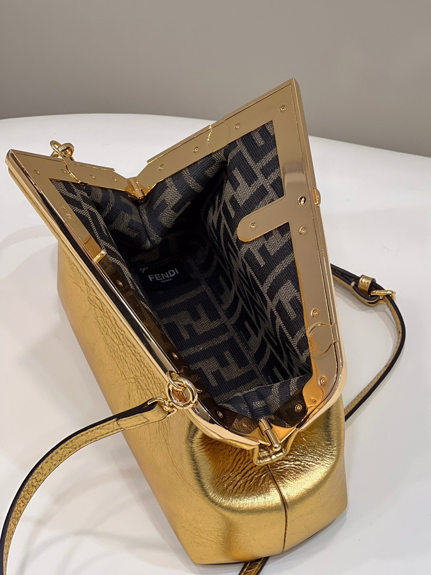 F**di first small bag in gold laminated leather