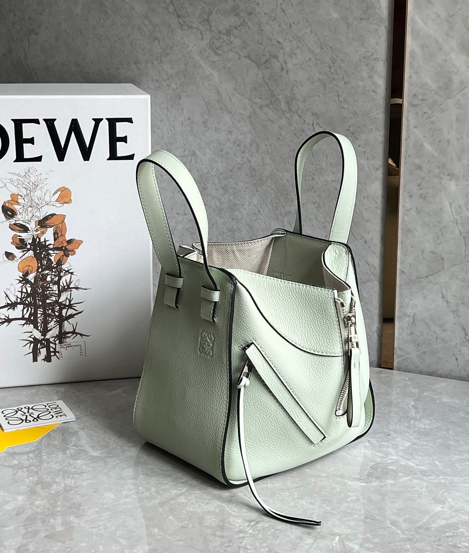 L0ew* compact hammock bag in light celadon grained calfskin