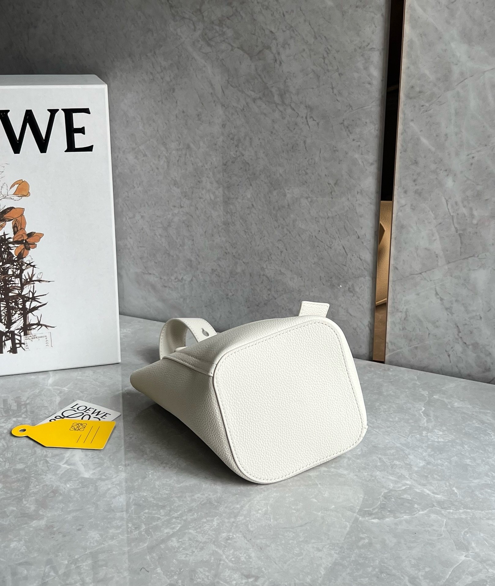 L0ew* mini pebble bucket bag in white grained leather