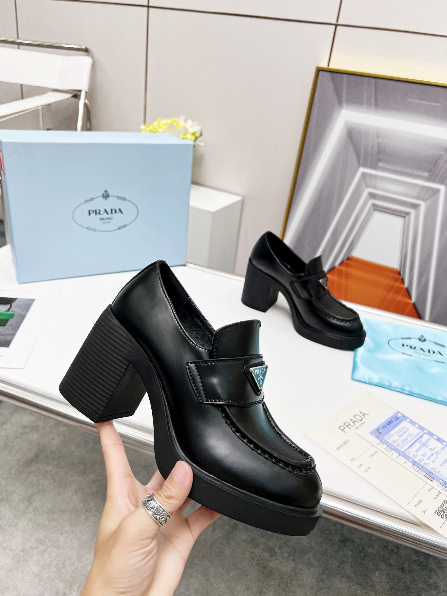 Pra*a chocolate high-heeled loafers in black brushed leather
