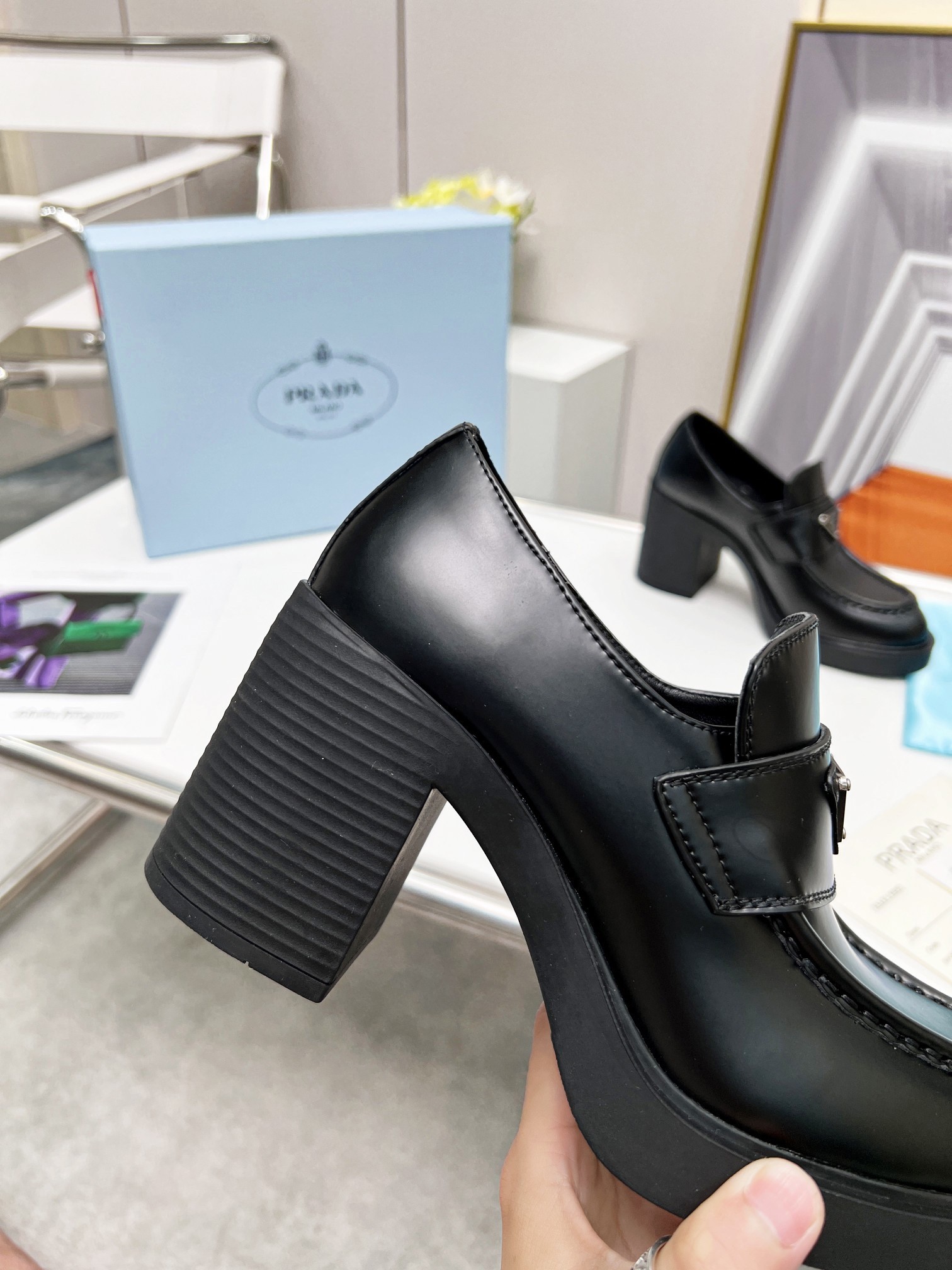Pra*a chocolate high-heeled loafers in black brushed leather