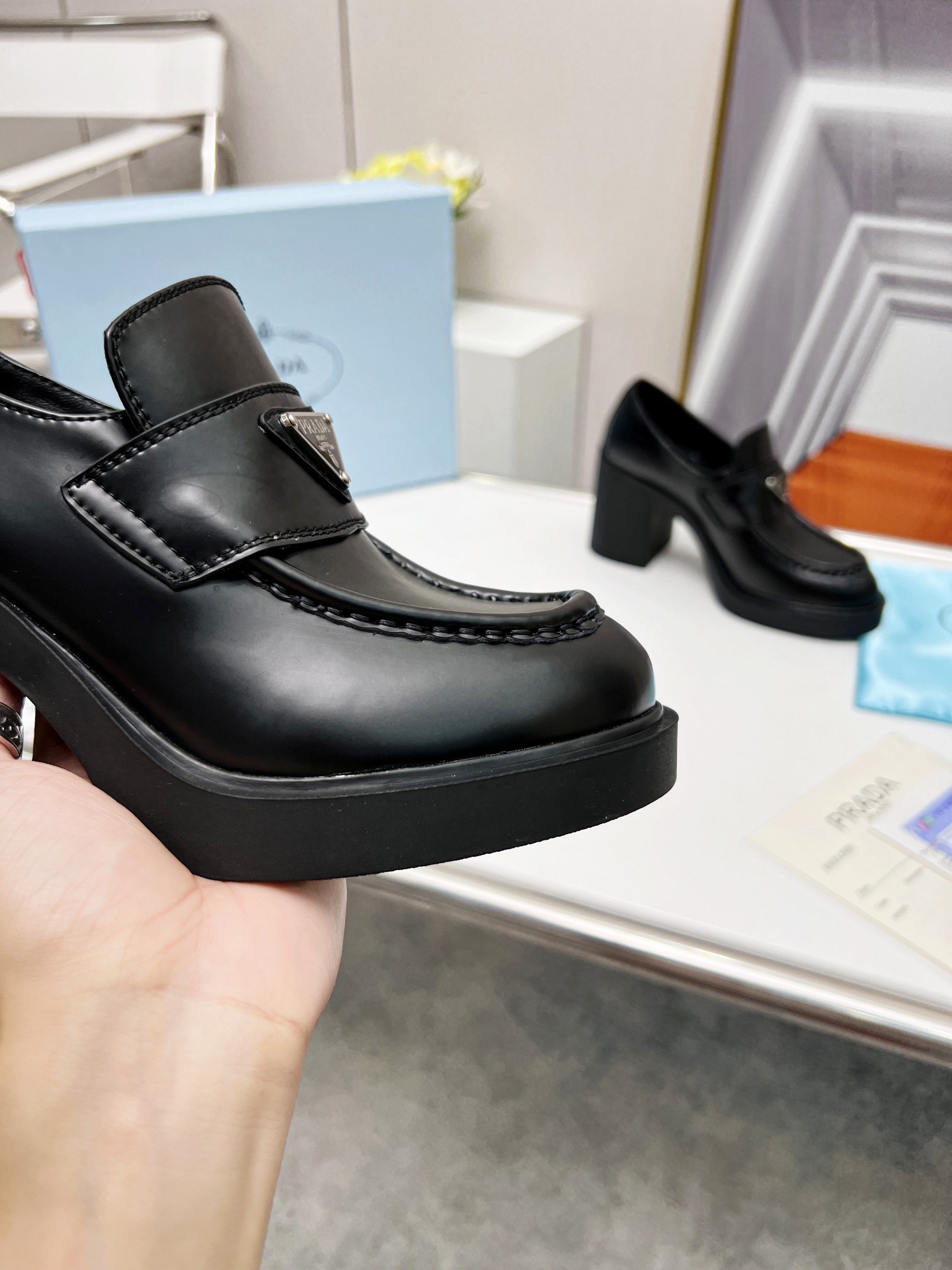 Pra*a chocolate high-heeled loafers in black brushed leather