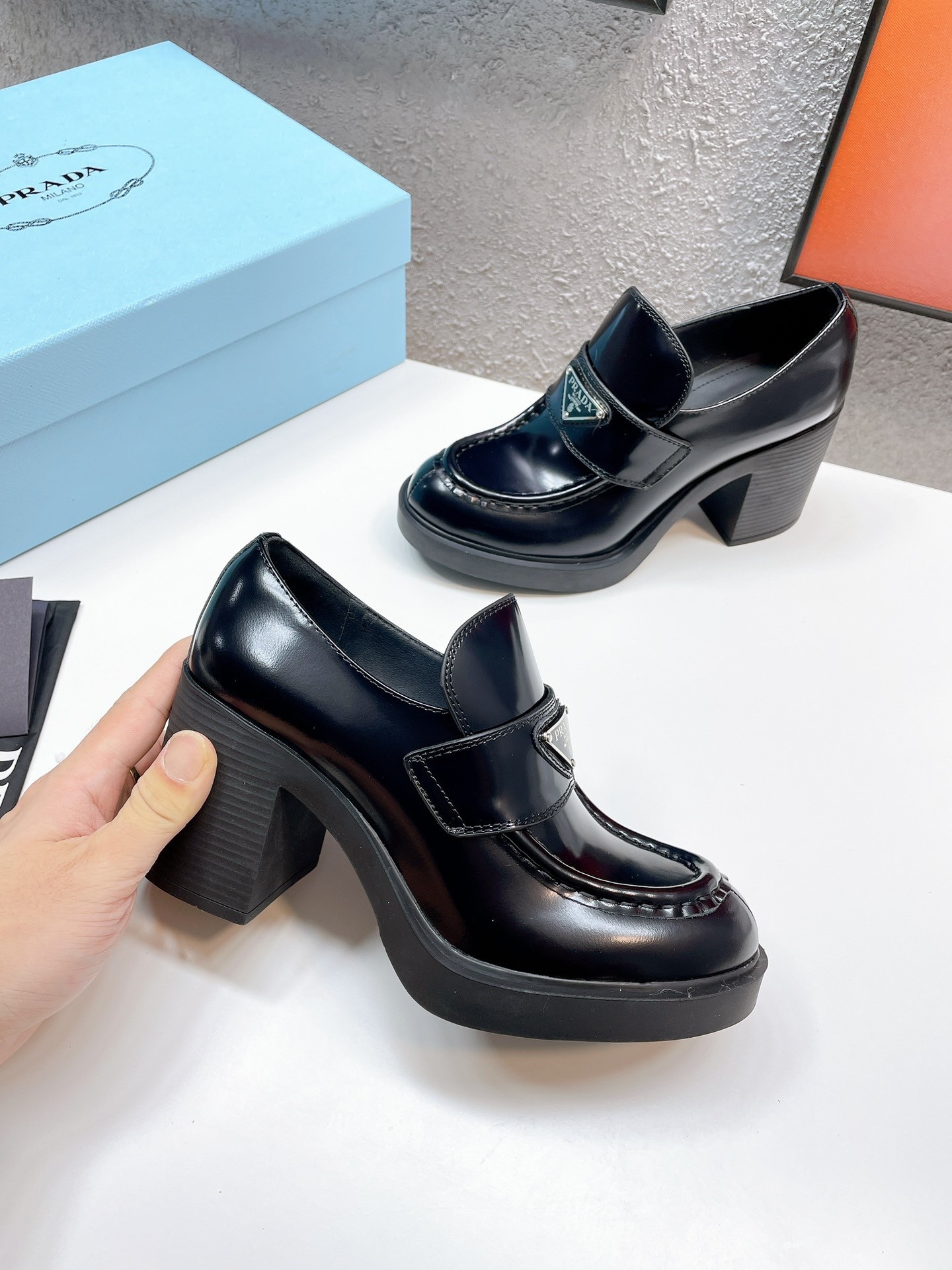 Pra*a chocolate high-heeled loafers in black brushed leather