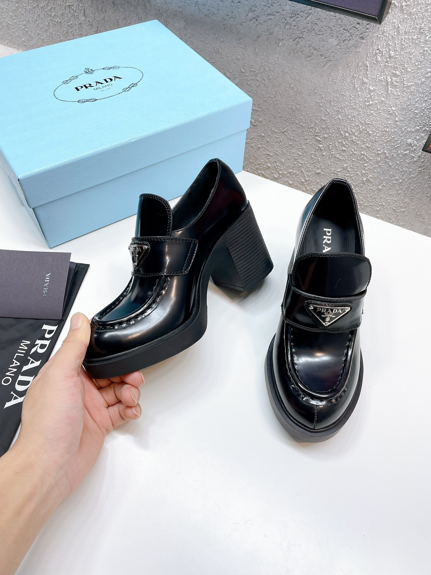 Pra*a chocolate high-heeled loafers in black brushed leather