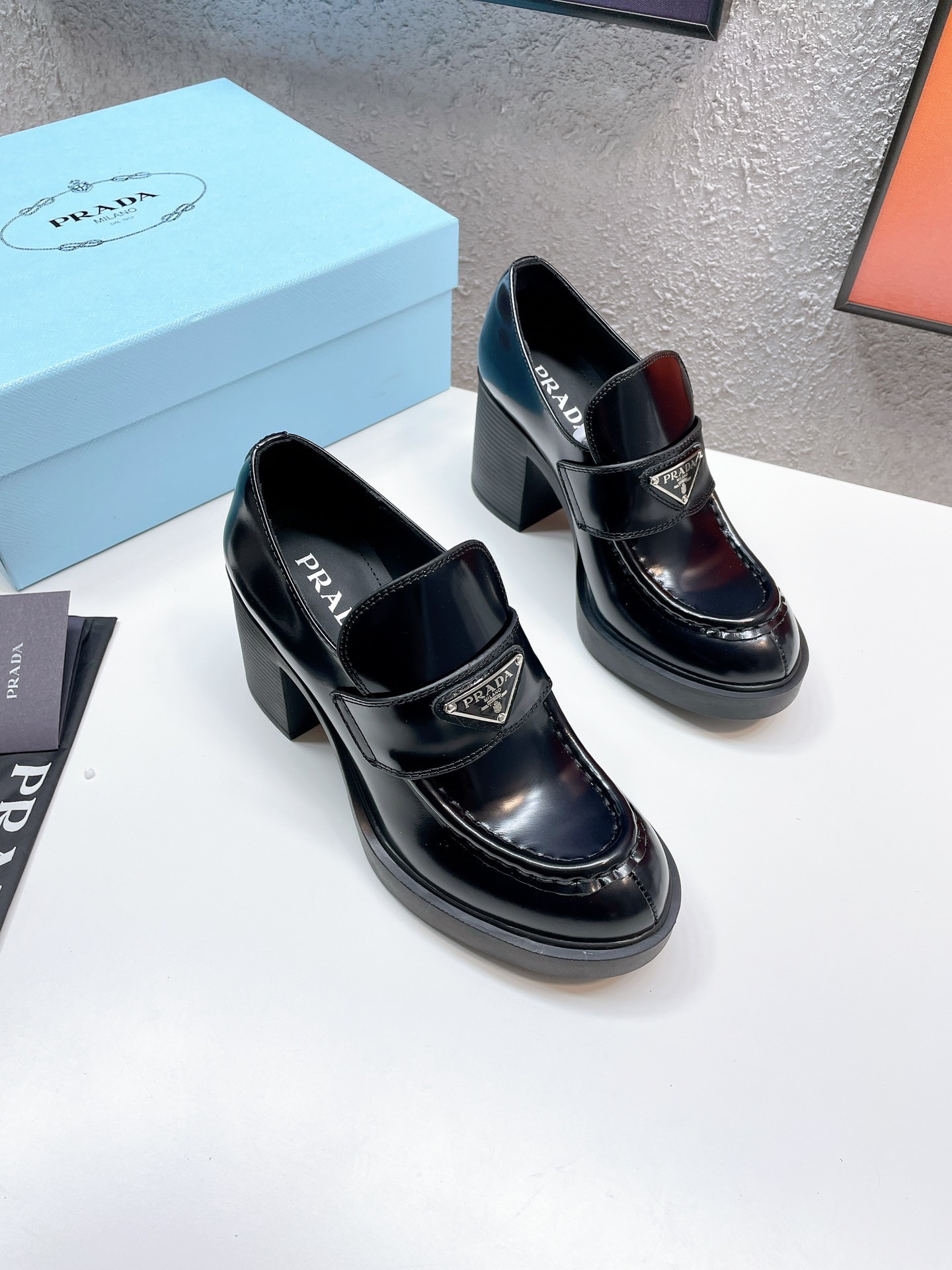 Pra*a chocolate high-heeled loafers in black brushed leather