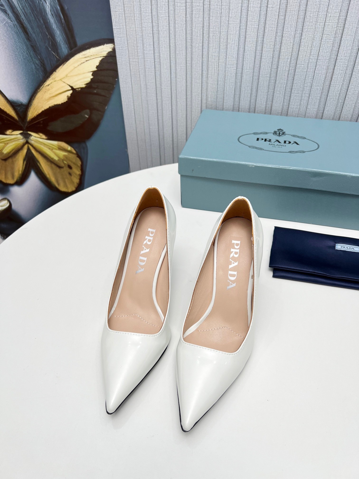Pra*a pumps 95mm in white patent leather
