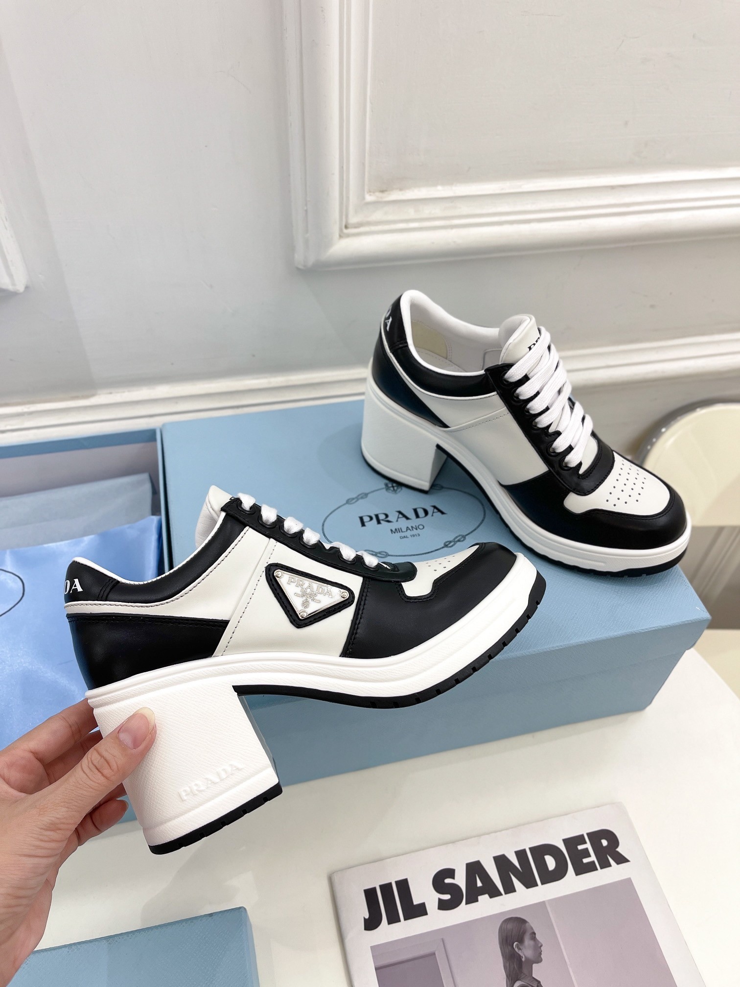 Pra*a downtown high-heeled sneakers in black and white leather