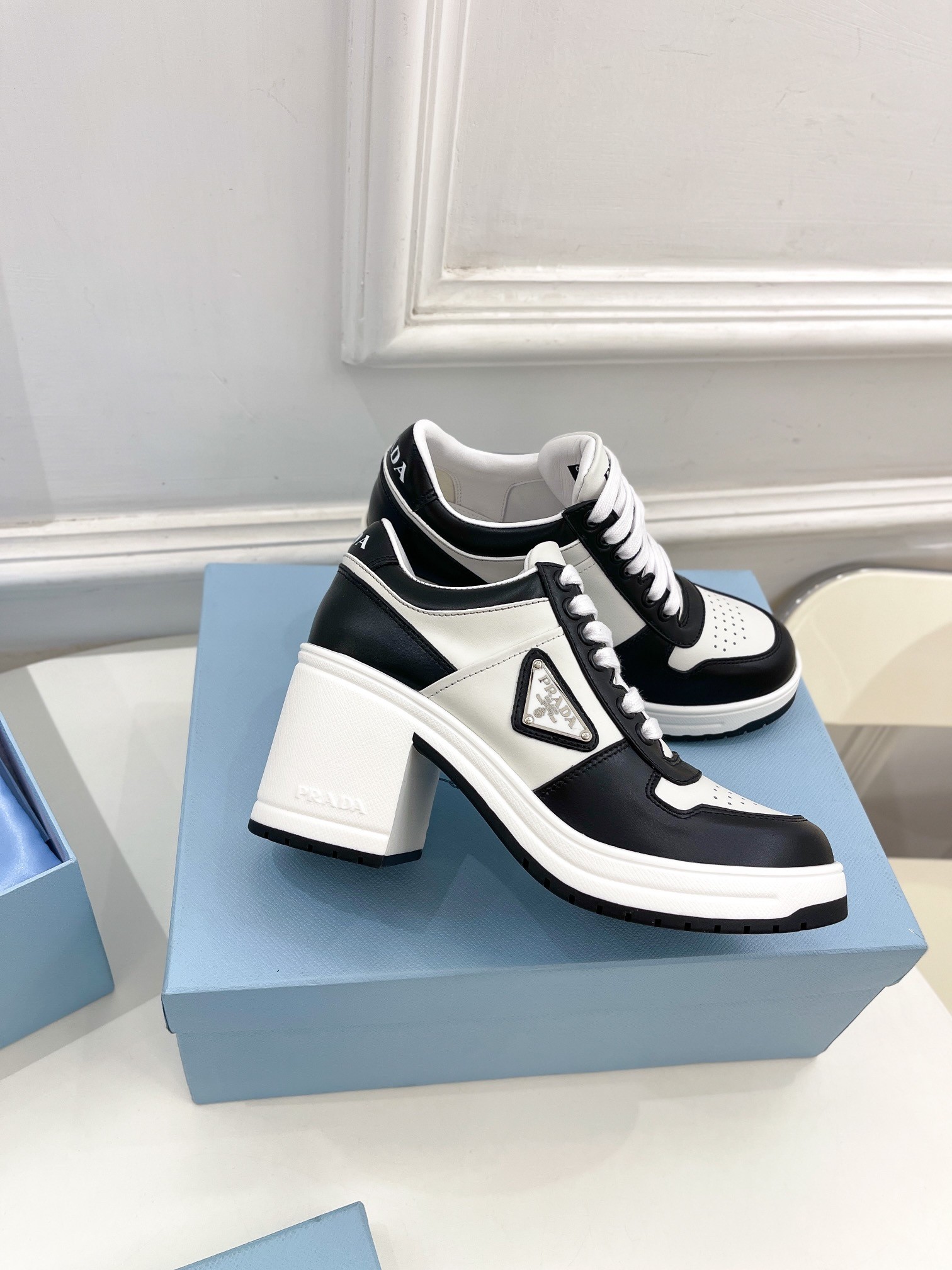 Pra*a downtown high-heeled sneakers in black and white leather