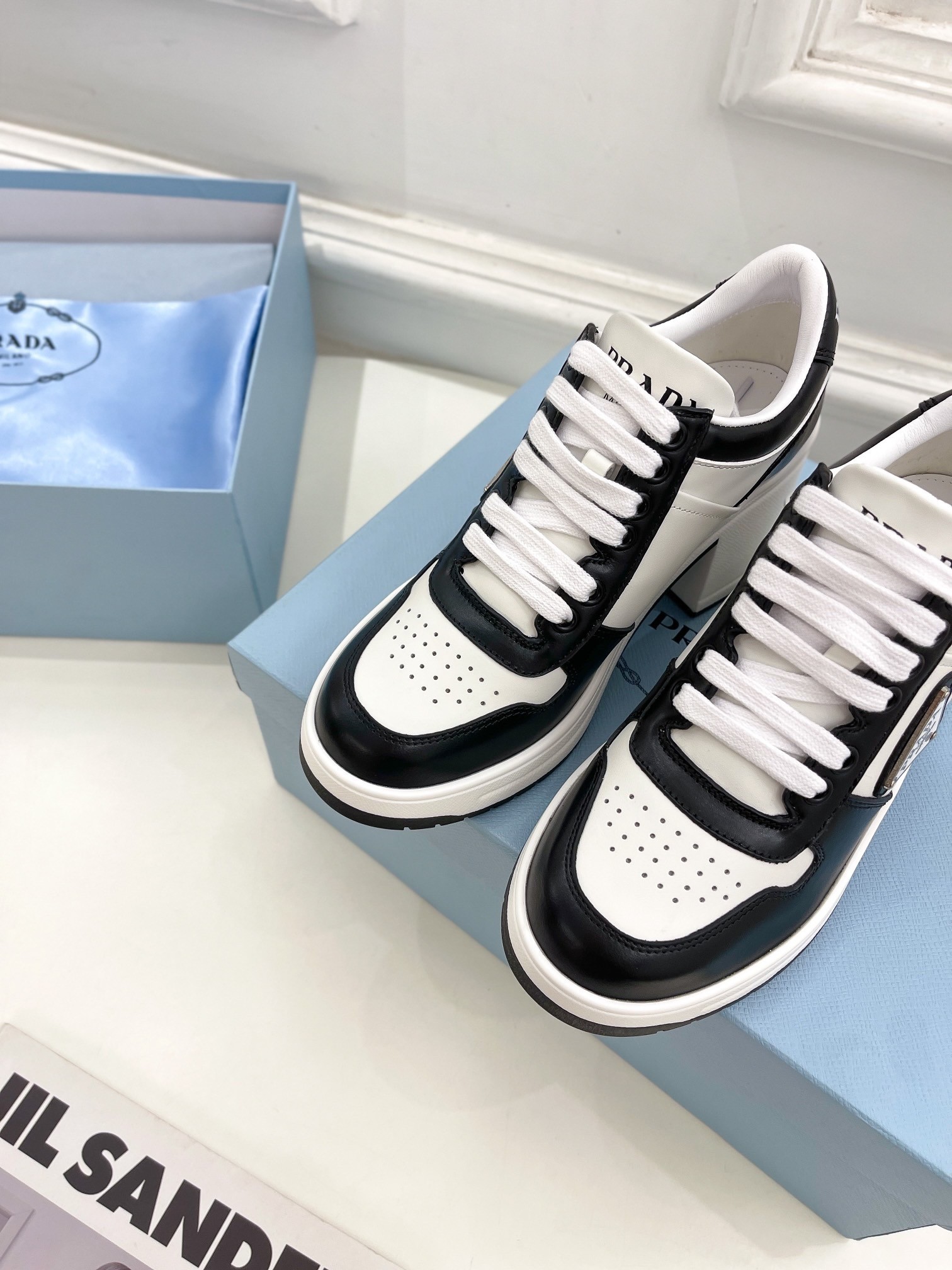 Pra*a downtown high-heeled sneakers in black and white leather