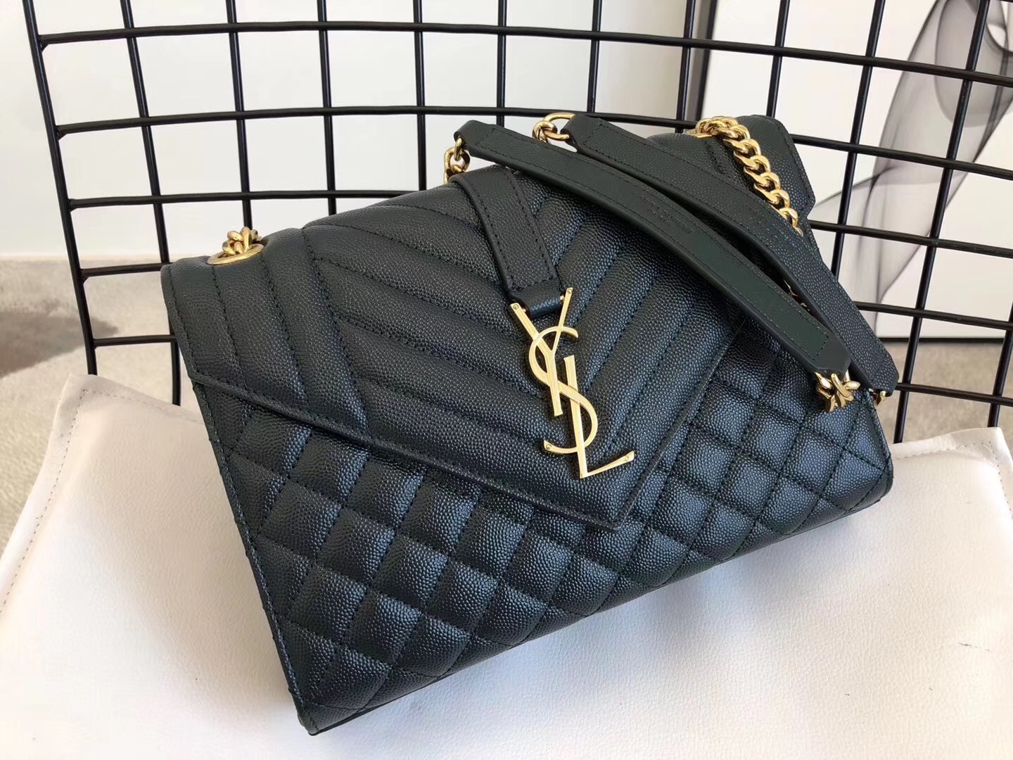 Sa**t Lau*nt medium envelope bag in dark green grained leather