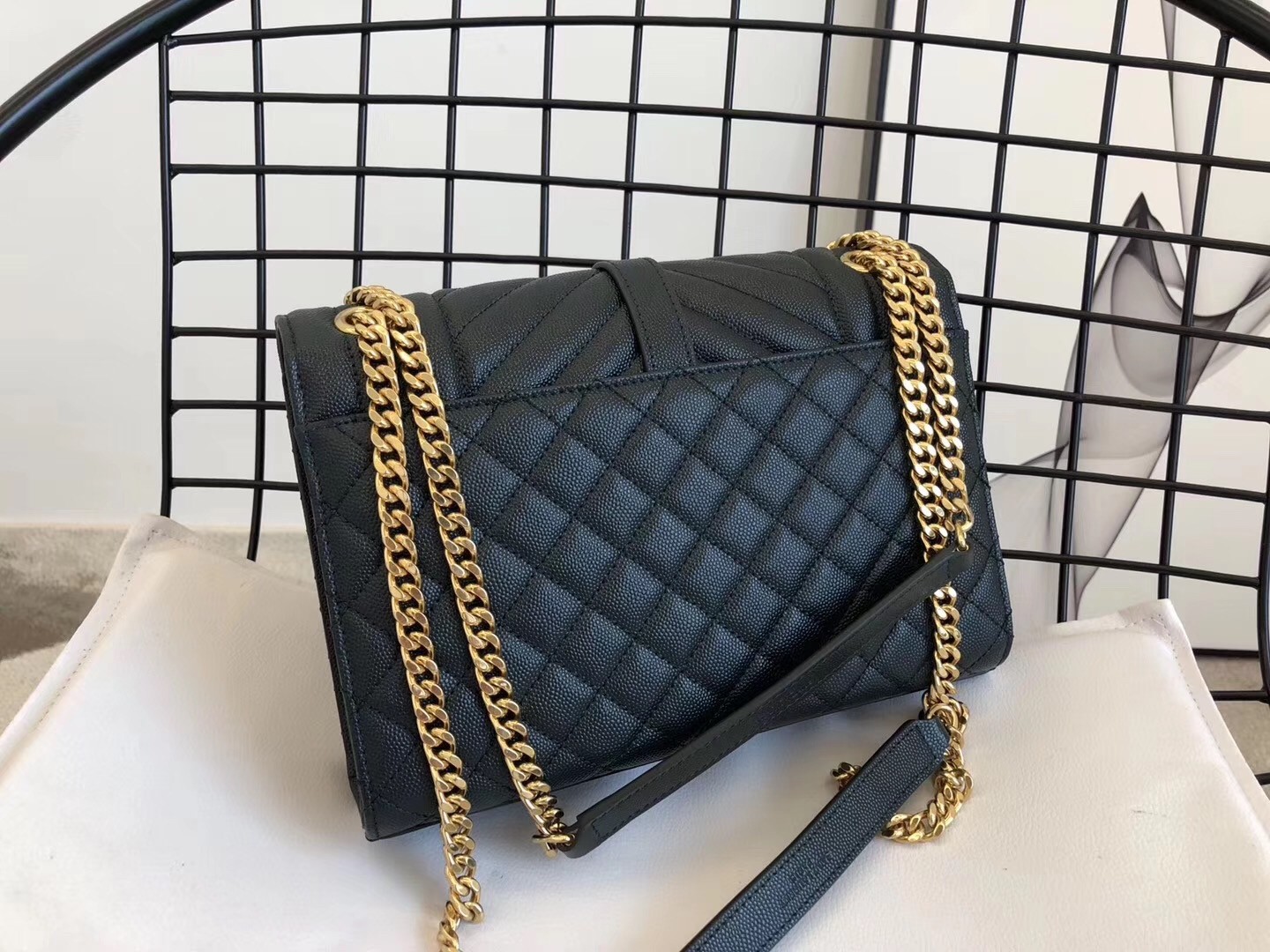 Sa**t Lau*nt medium envelope bag in dark green grained leather
