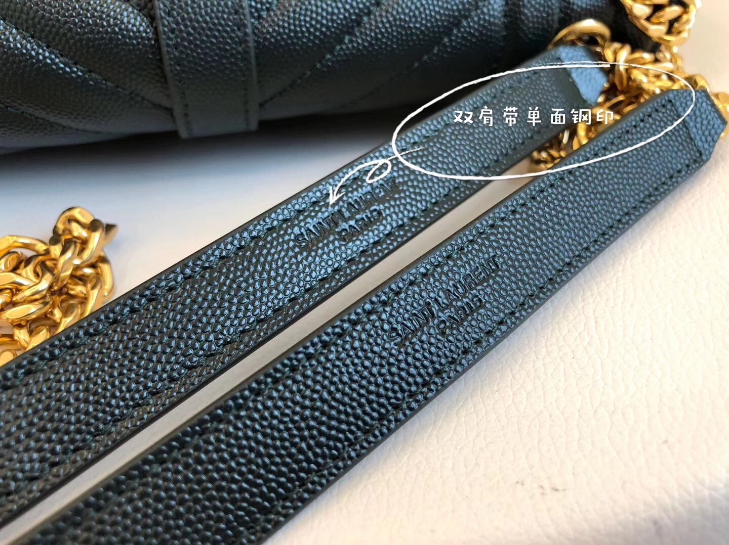 Sa**t Lau*nt medium envelope bag in dark green grained leather